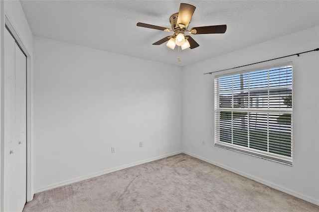141 Winsor Ave, Davenport, FL 33837 - unfurnished bedroom with carpet floors, a closet, a ceiling fan, and a textured ceiling