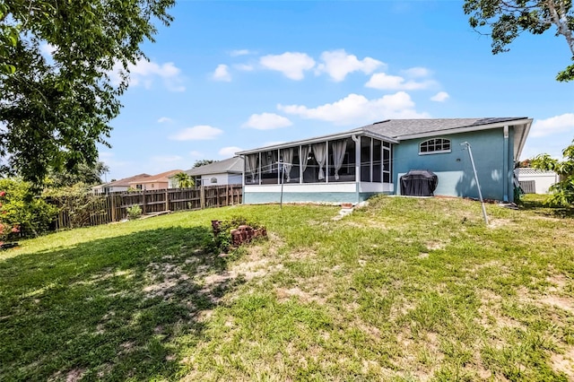 141 Winsor Ave, Davenport, FL 33837 - rear view of property with a sunroom and stucco siding