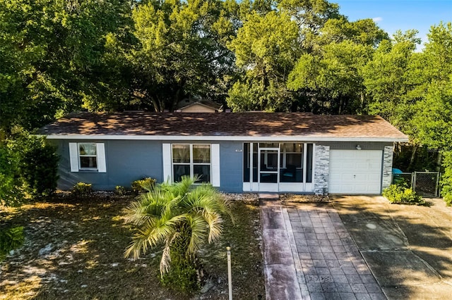 1649 Weybridge St, Deltona, FL 32725 - single story home with a shingled roof, an attached garage, concrete block siding, and driveway