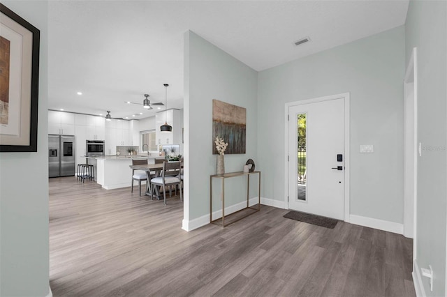 9353 Gotha Rd, Windermere, FL 34786 - entryway featuring ceiling fan, wood finished floors, and recessed lighting