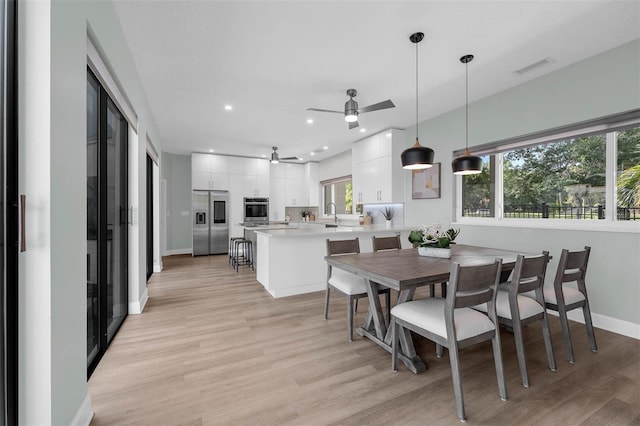 9353 Gotha Rd, Windermere, FL 34786 - dining space with a ceiling fan, light wood finished floors, and recessed lighting