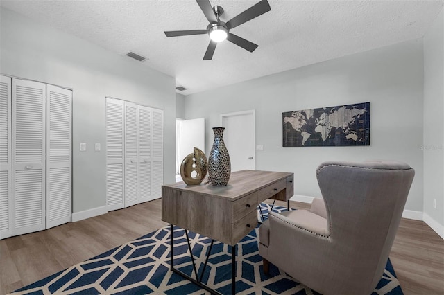 9353 Gotha Rd, Windermere, FL 34786 - office space with wood finished floors, a ceiling fan, and a textured ceiling