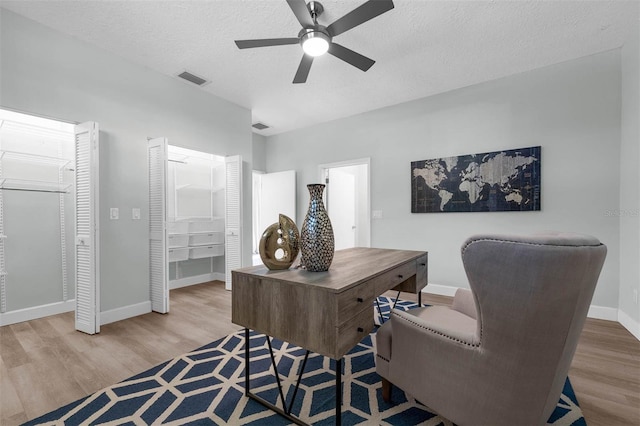 9353 Gotha Rd, Windermere, FL 34786 - home office with wood finished floors, a ceiling fan, and a textured ceiling