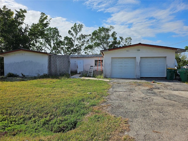 801 Marlin Dr, Punta Gorda, FL 33950 - view of front of house featuring a garage and a front lawn