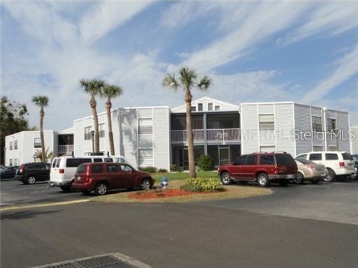 3863 Atrium Dr Unit L-6, Orlando, FL 32822 - view of building exterior featuring uncovered parking