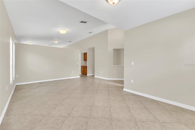 1753 Sage Creek Ct, Orlando, FL 32824 - empty room featuring vaulted ceiling and light tile patterned floors