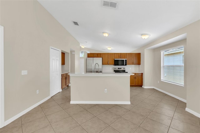 1753 Sage Creek Ct, Orlando, FL 32824 - kitchen featuring stainless steel refrigerator with ice dispenser, brown cabinetry, light tile patterned floors, light countertops, and vaulted ceiling