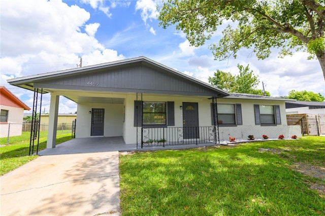 4469 Evers Pl, Orlando, FL 32811 - view of front facade with driveway, a porch, an attached carport, brick siding, and stucco siding