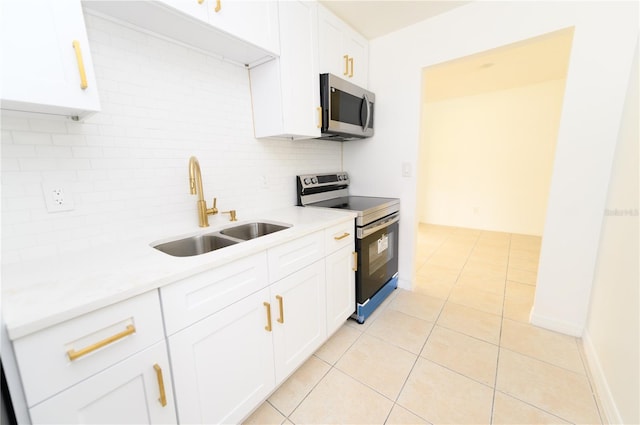 4469 Evers Pl, Orlando, FL 32811 - kitchen with stainless steel appliances, backsplash, light countertops, and light tile patterned floors
