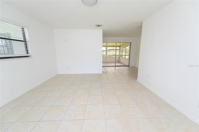 4469 Evers Pl, Orlando, FL 32811 - empty room with light tile patterned floors and baseboards