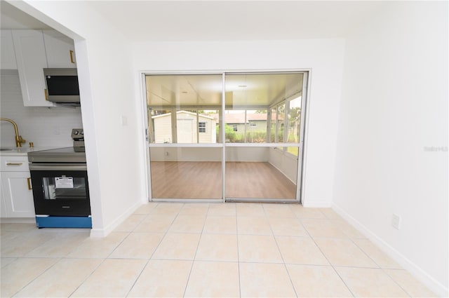 4469 Evers Pl, Orlando, FL 32811 - unfurnished dining area featuring light tile patterned floors and baseboards