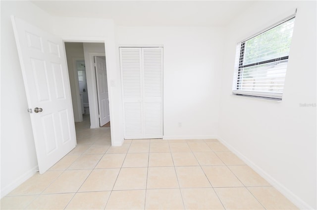 4469 Evers Pl, Orlando, FL 32811 - unfurnished bedroom with light tile patterned floors and a closet