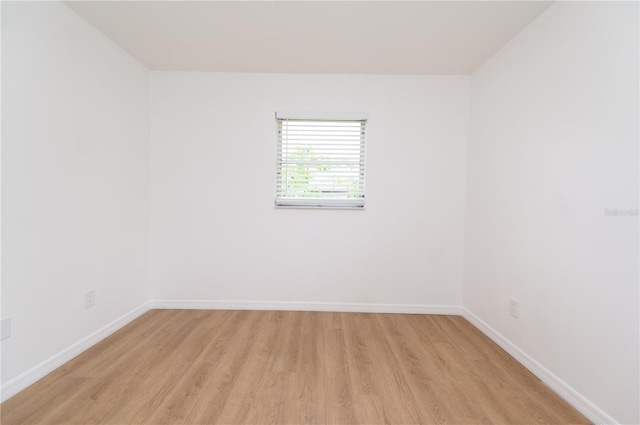 4469 Evers Pl, Orlando, FL 32811 - empty room with light wood finished floors and baseboards