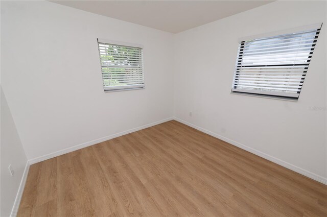 4469 Evers Pl, Orlando, FL 32811 - spare room featuring light wood-style floors and baseboards