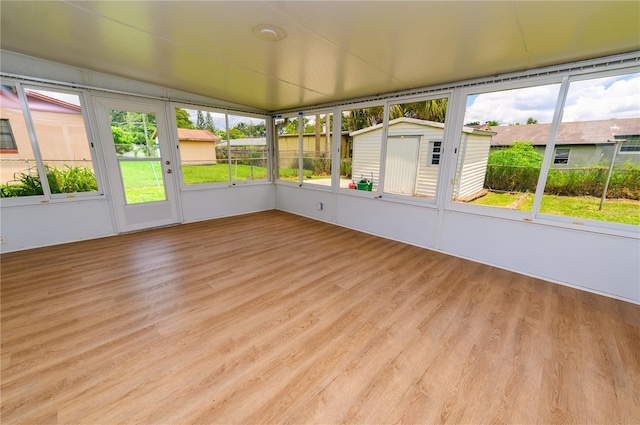 4469 Evers Pl, Orlando, FL 32811 - unfurnished sunroom with healthy amount of natural light and lofted ceiling