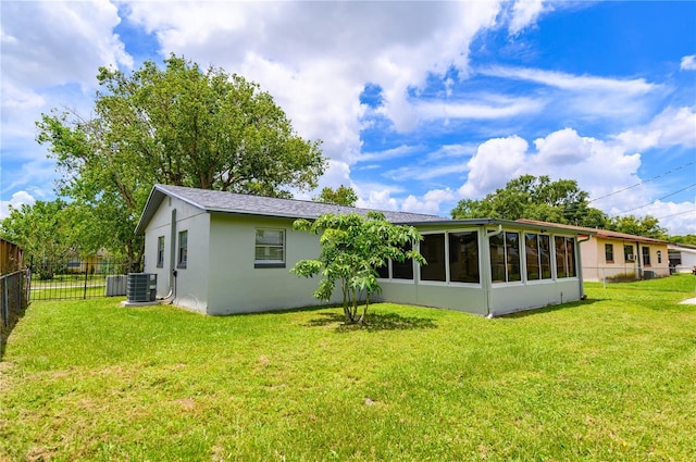 4469 Evers Pl, Orlando, FL 32811 - rear view of house with a sunroom and stucco siding