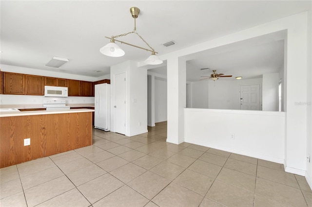 5145 Prairie View Way, Wesley Chapel, FL 33545 - kitchen with white appliances, light countertops, ceiling fan, pendant lighting, and brown cabinets