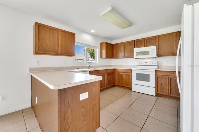 5145 Prairie View Way, Wesley Chapel, FL 33545 - kitchen featuring white appliances, a peninsula, brown cabinets, light tile patterned floors, and light countertops