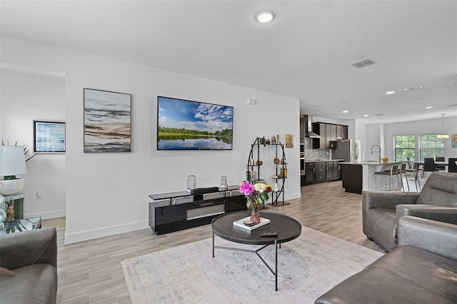 461 Diamond Dove Cv, Winter Springs, FL 32708 - living area featuring light wood-style flooring, a textured ceiling, and recessed lighting