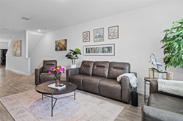 461 Diamond Dove Cv, Winter Springs, FL 32708 - living area with light wood-type flooring and a textured ceiling