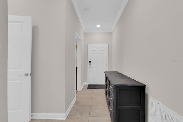 hall featuring ornamental molding and light tile patterned flooring