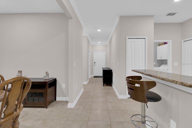corridor with light tile patterned floors, recessed lighting, and crown molding