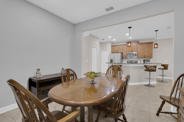 dining room with light tile patterned floors and recessed lighting