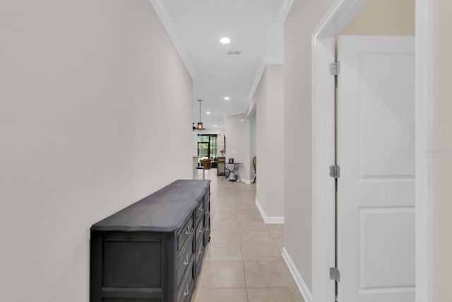 corridor with ornamental molding, light tile patterned floors, and recessed lighting