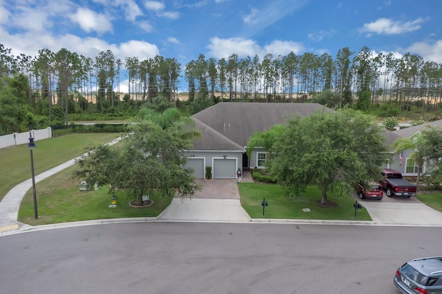 view of front of property featuring a garage, driveway, and stucco siding