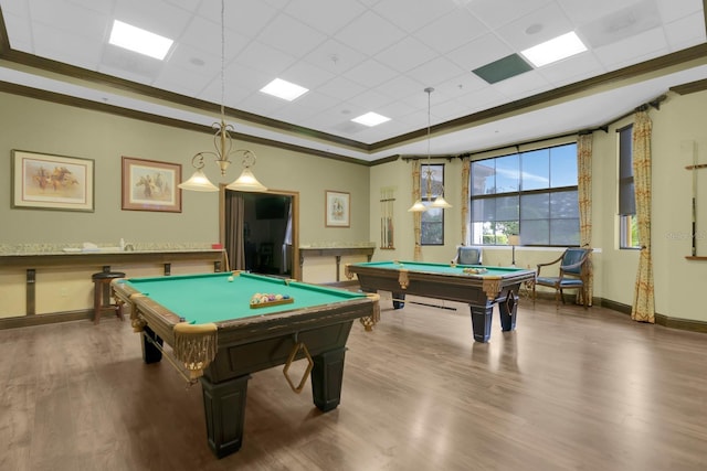 playroom with pool table, wood finished floors, a paneled ceiling, crown molding, and a tray ceiling