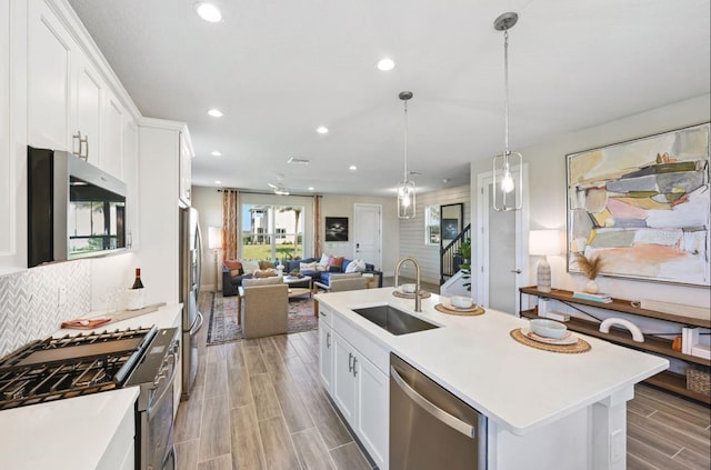 2563 Long Pine Ave, Apopka, FL 32712 - kitchen featuring appliances with stainless steel finishes, open floor plan, a center island with sink, recessed lighting, and white cabinets