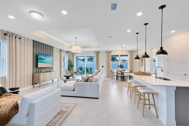 1530 Groveline Rd, Saint Cloud, FL 34771 - living room featuring a raised ceiling, recessed lighting, and light tile patterned floors