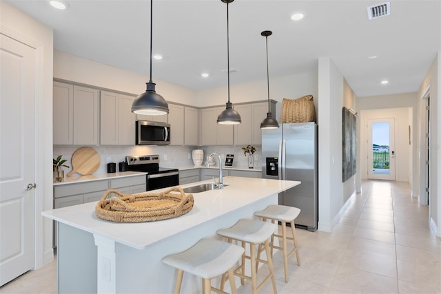 1530 Groveline Rd, Saint Cloud, FL 34771 - kitchen featuring stainless steel appliances, gray cabinetry, decorative backsplash, light countertops, and recessed lighting