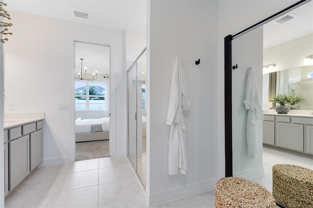 1530 Groveline Rd, Saint Cloud, FL 34771 - ensuite bathroom featuring vanity, a chandelier, a shower stall, and tile patterned flooring