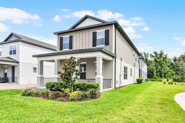 505 Venetian Palms Blvd, New Smyrna Beach, FL 32168 - view of side of home with covered porch, board and batten siding, a lawn, and stucco siding