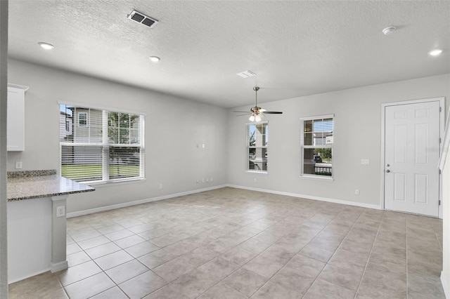 505 Venetian Palms Blvd, New Smyrna Beach, FL 32168 - unfurnished dining area featuring a textured ceiling, a ceiling fan, light tile patterned floors, and recessed lighting