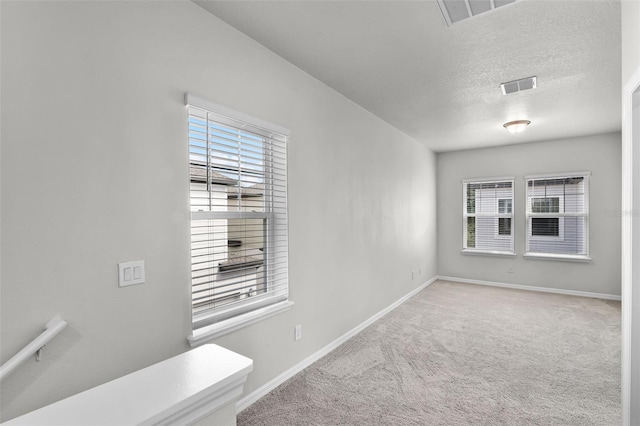 505 Venetian Palms Blvd, New Smyrna Beach, FL 32168 - unfurnished room with carpet floors and a textured ceiling