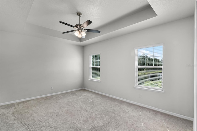 505 Venetian Palms Blvd, New Smyrna Beach, FL 32168 - carpeted empty room with a tray ceiling, plenty of natural light, a ceiling fan, and a textured ceiling