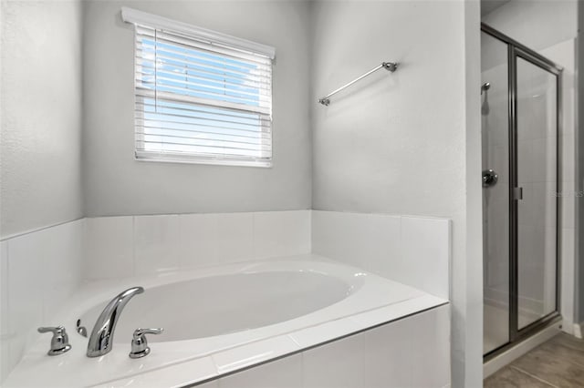 505 Venetian Palms Blvd, New Smyrna Beach, FL 32168 - bathroom with a shower stall, a garden tub, and tile patterned flooring