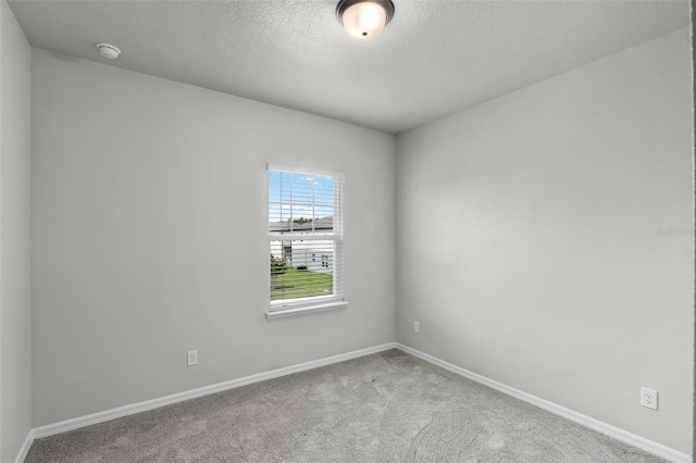 505 Venetian Palms Blvd, New Smyrna Beach, FL 32168 - carpeted empty room featuring a textured ceiling and a smoke detector