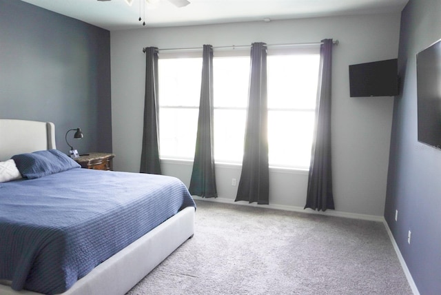 bedroom featuring multiple windows, carpet, and ceiling fan