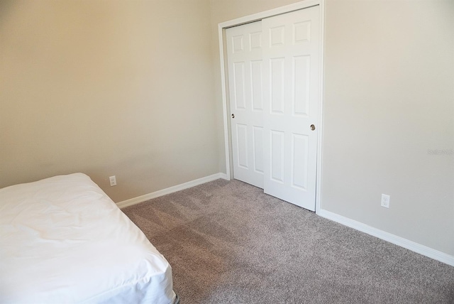 unfurnished bedroom featuring carpet floors and baseboards
