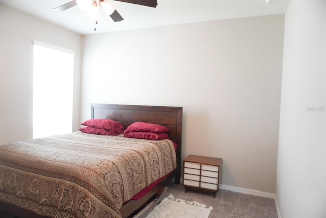 carpeted bedroom featuring ceiling fan and baseboards