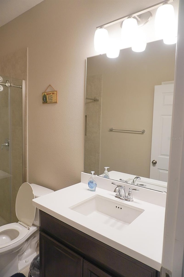 bathroom featuring vanity and a shower stall