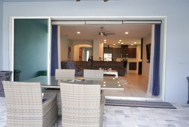view of patio with a ceiling fan and outdoor dining area