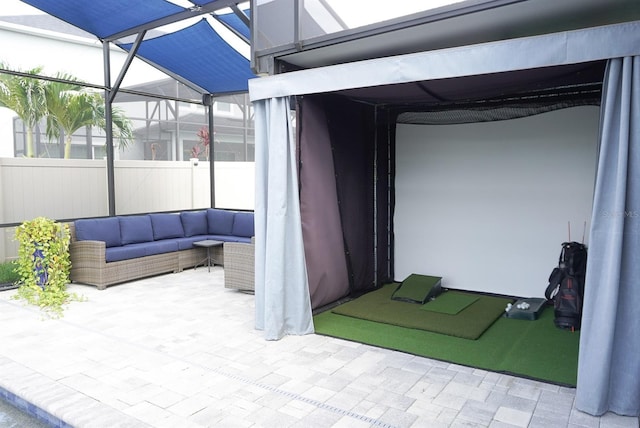 view of patio with outdoor lounge area and glass enclosure