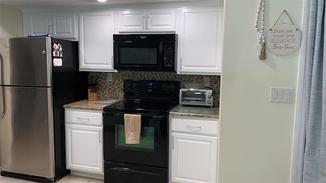 1409 Yorkshire St, Port Charlotte, FL 33952 - kitchen with black appliances, decorative backsplash, and white cabinetry