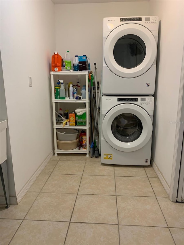 1409 Yorkshire St, Port Charlotte, FL 33952 - laundry room with stacked washing machine and dryer and light tile patterned flooring