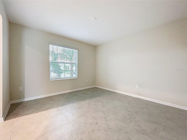 16436 Fernridge St, Clermont, FL 34714 - spare room featuring light tile patterned floors and baseboards