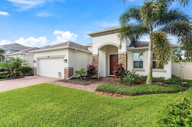 1181 Castlevecchio Loop, Orlando, FL 32825 - view of front facade featuring stucco siding, stone siding, decorative driveway, and an attached garage